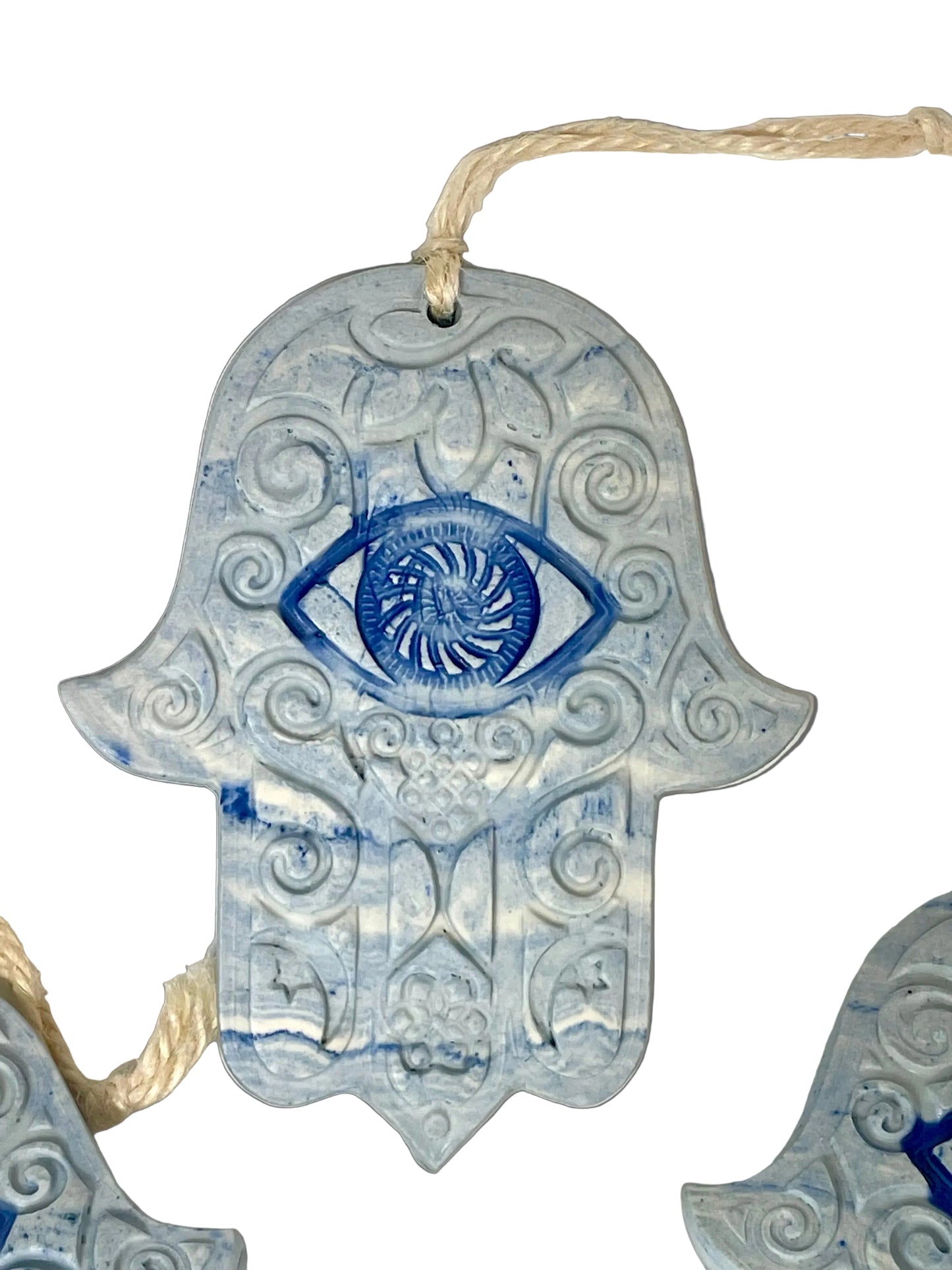 Decorative Hamsa hand with blue eye design on marbled white & cobalt porcelain